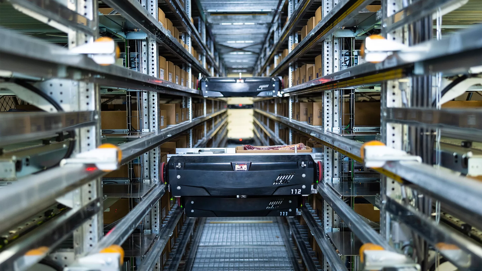 Automated miniload shuttle storing small electronics cartons in high-density shelving